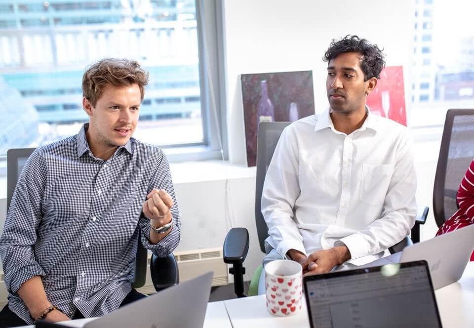 Two businessmen sitting next to each other