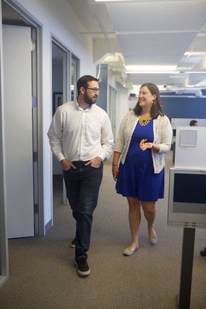 2 people talking in an office