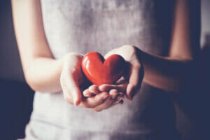 Overall well-being: woman holding red heart