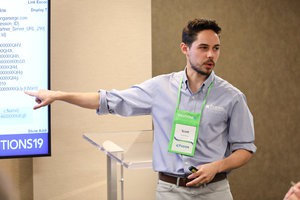 Man speaking and pointing to tv